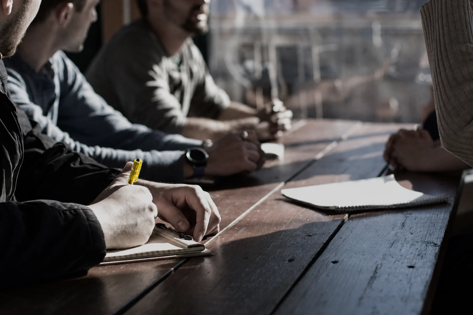 People working through an idea together around a table